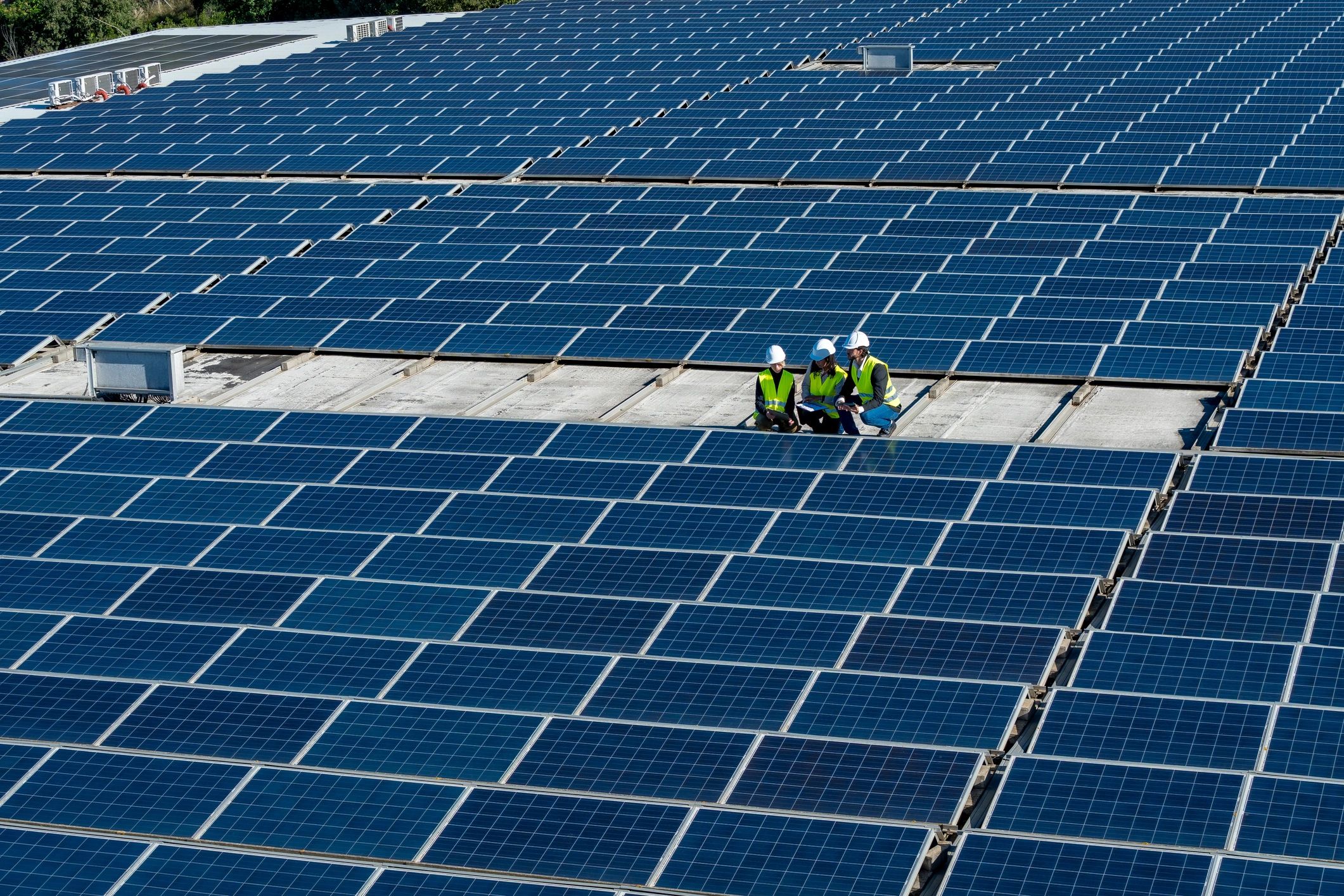 Engineers reviewing a commercial rooftop solar array