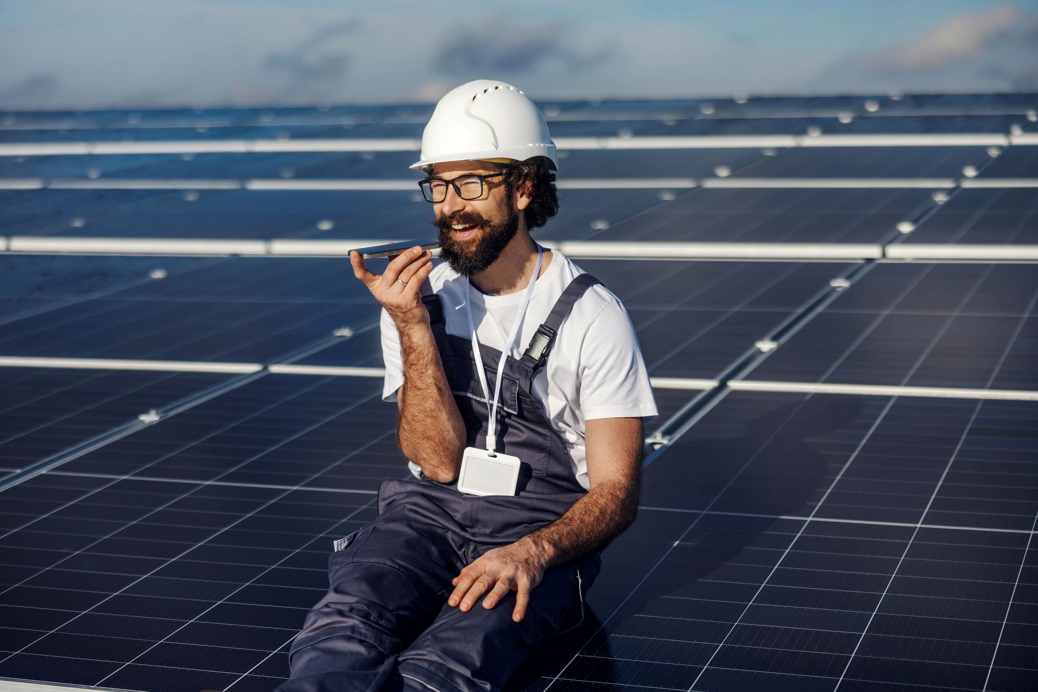 Technician communicating on phone at solar farm